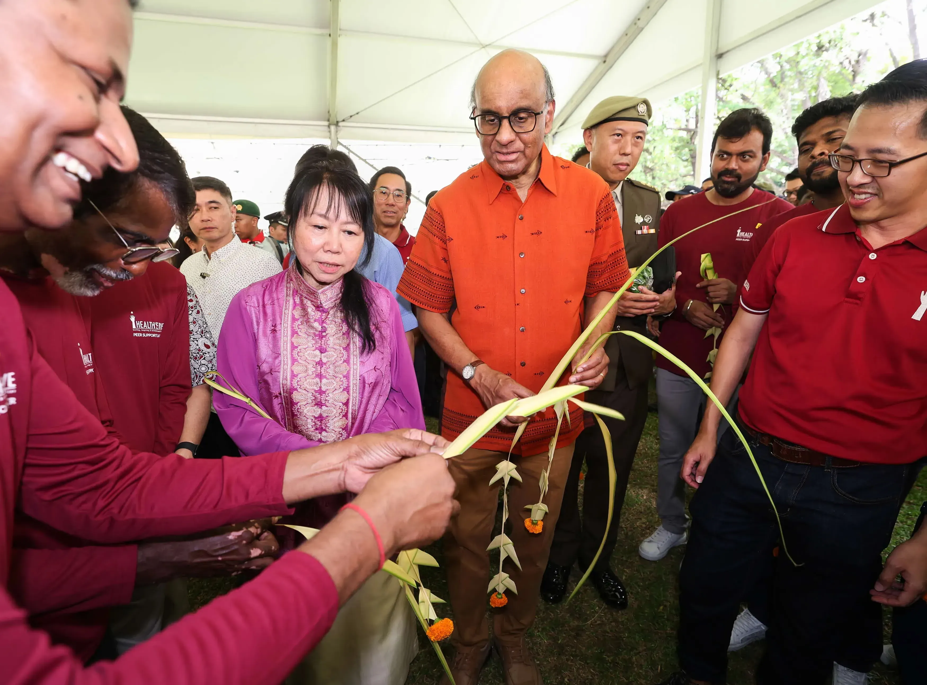 Mr and Mrs Tharman participating in weaving activities 